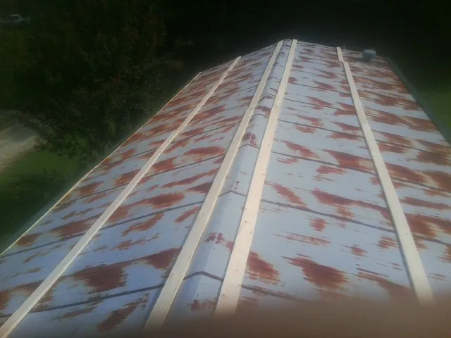 Rusted metal roof panels with new wood purlins before replacement — Storm Damage Roof Repair in Park Hall by Roofing Brothers