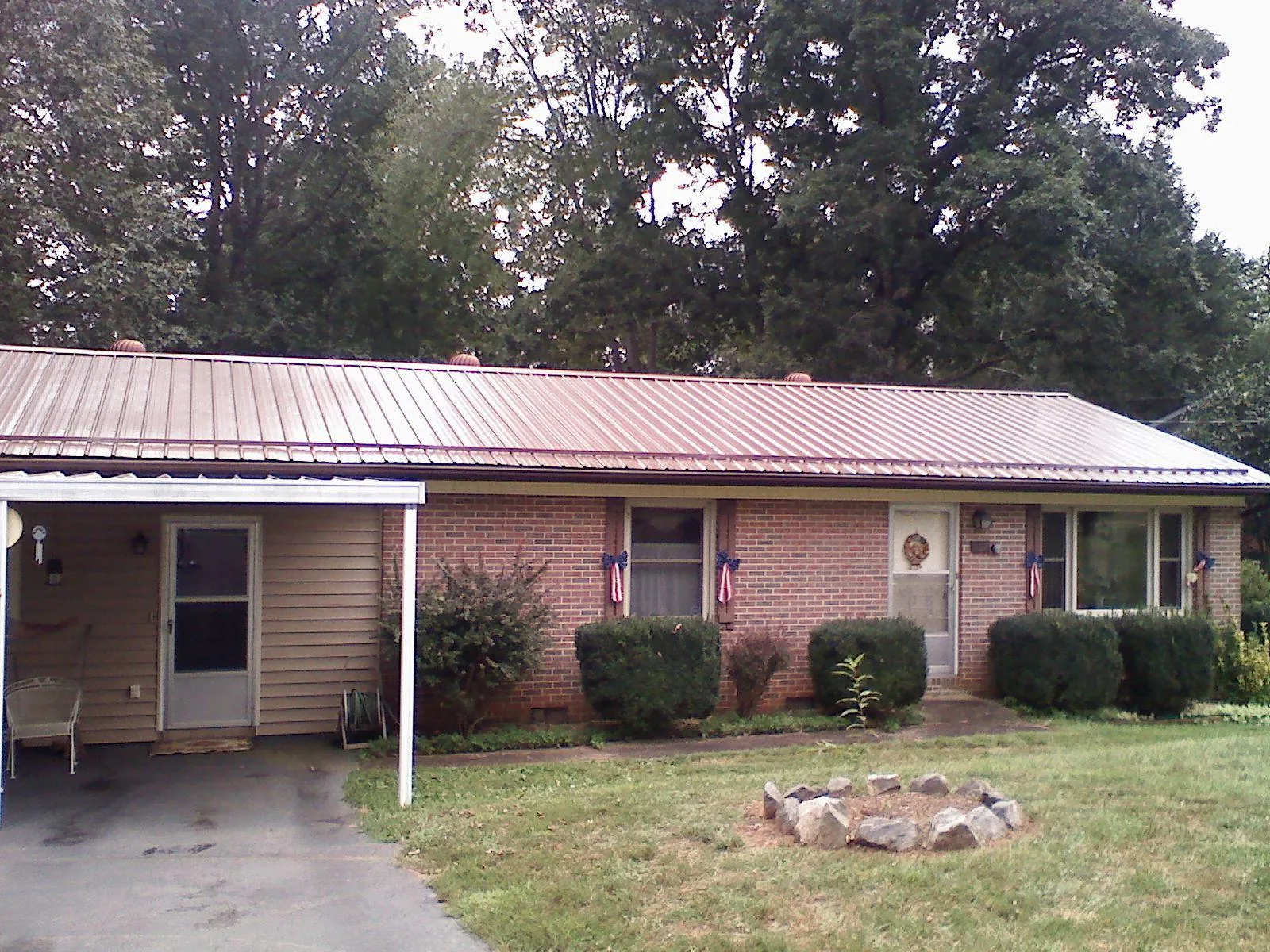 Bronze metal roof and carport on a brick ranch home — Roof Repair work by our crew in Park Hall